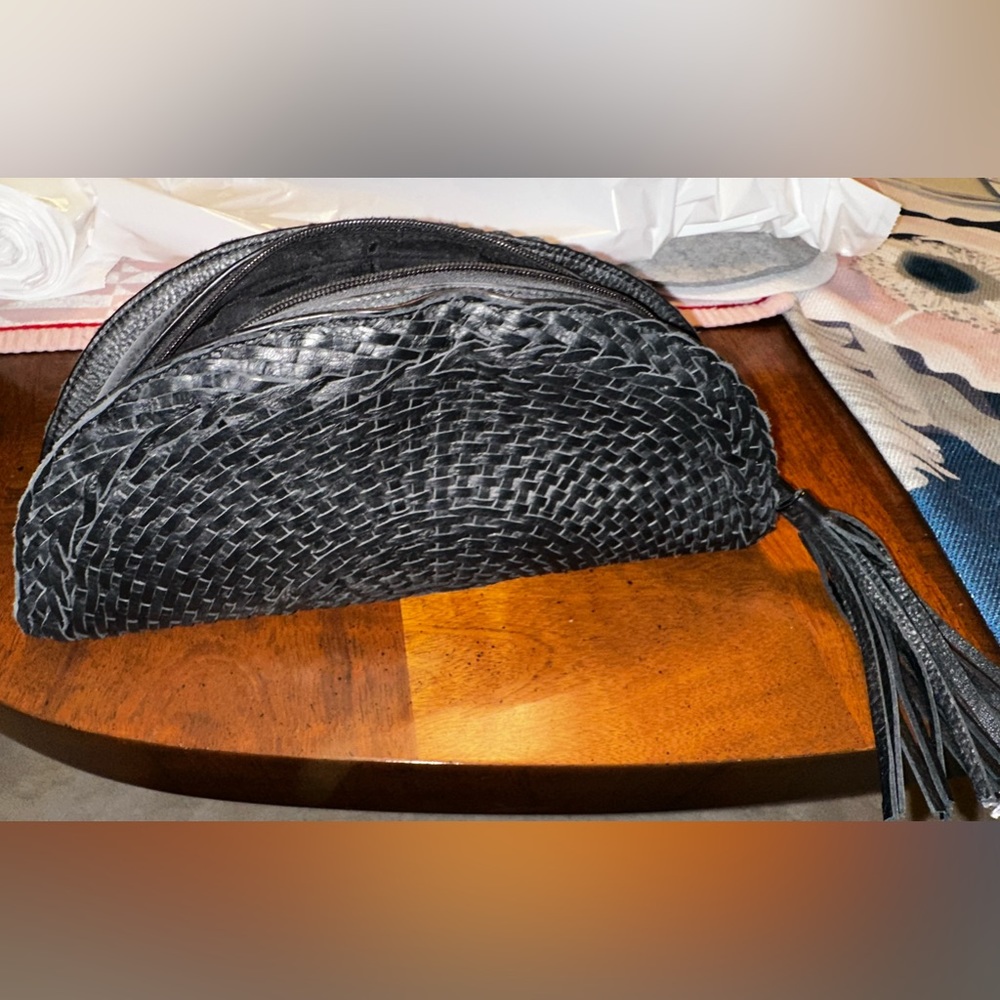 Black clutch handbag with half moon woven design made by Bloomingdales.
